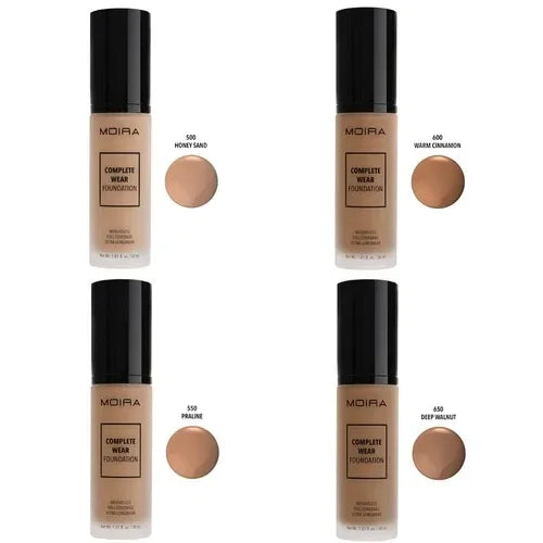 Four shades of MOIRA Complete Wear Foundation bottles with matching foundation swatches labeled Honey Sand, Warm Cinnamon, Praline, and Deep Walnut.