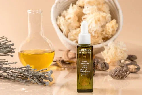 Super Bioactive Face Serum bottle surrounded by natural ingredients and a glass container with golden oil